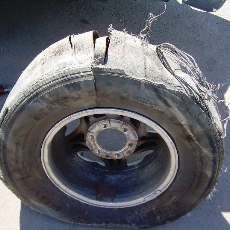 Inspecting failed Continental ContiTrac tire that led to rollover of pickup